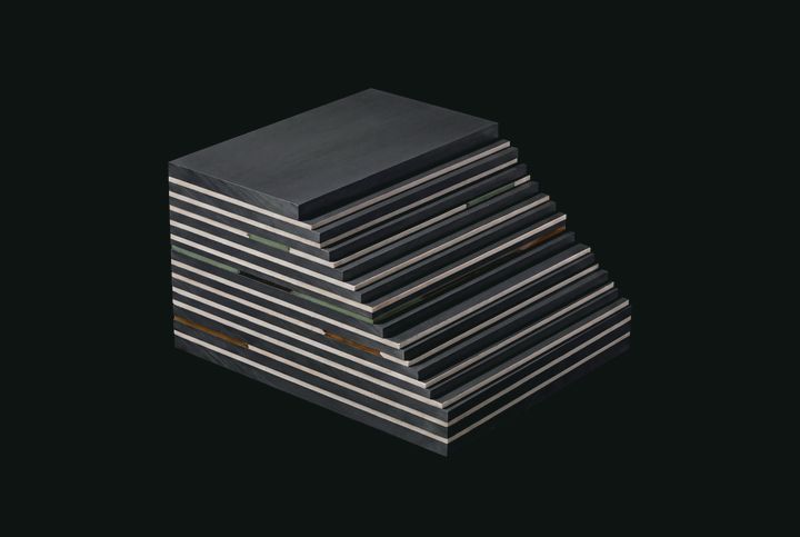 Stacked precision-cut graphite and mineral planes.